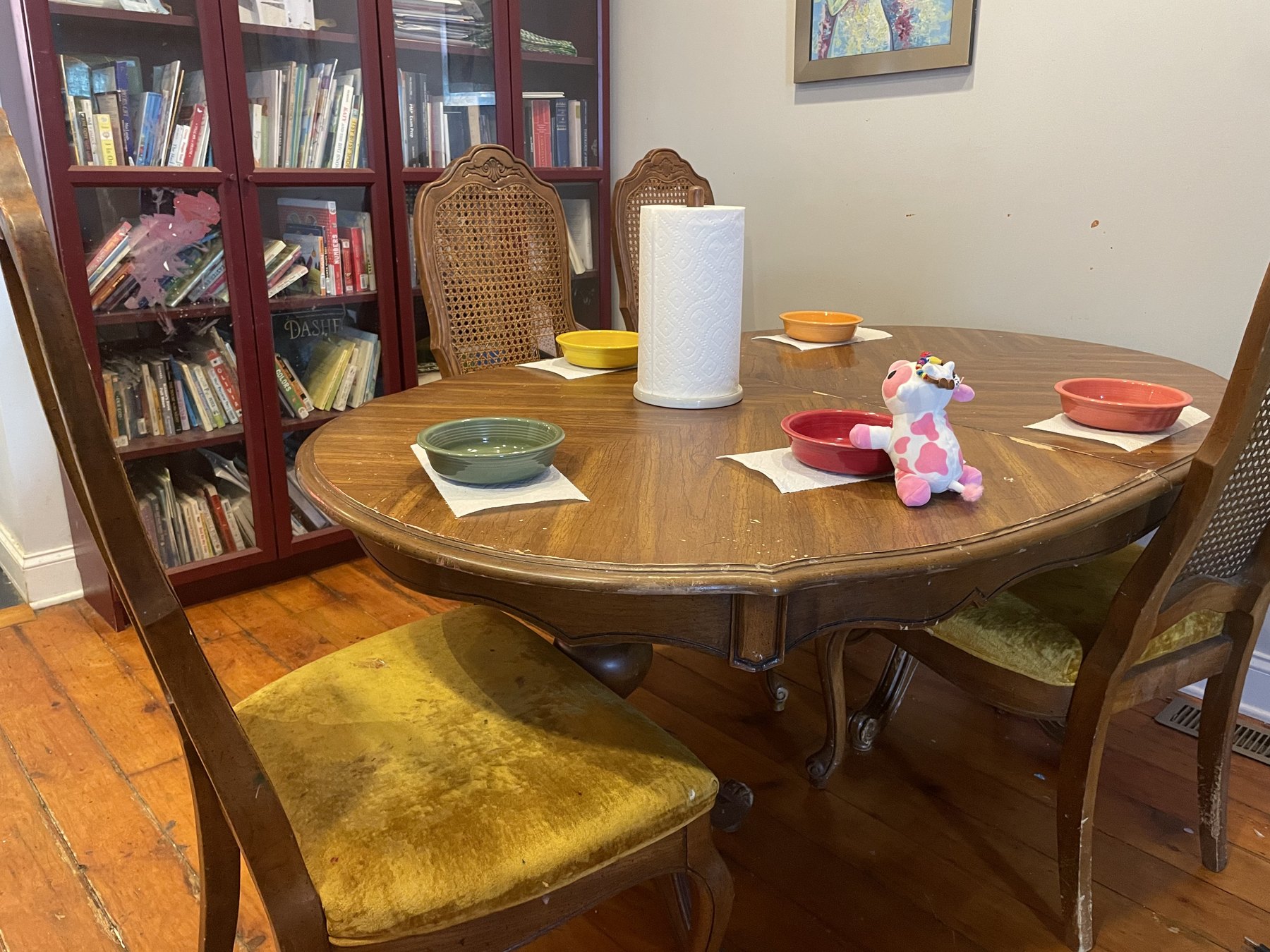 A family dining table reset for a meal after the school materials have been put away.